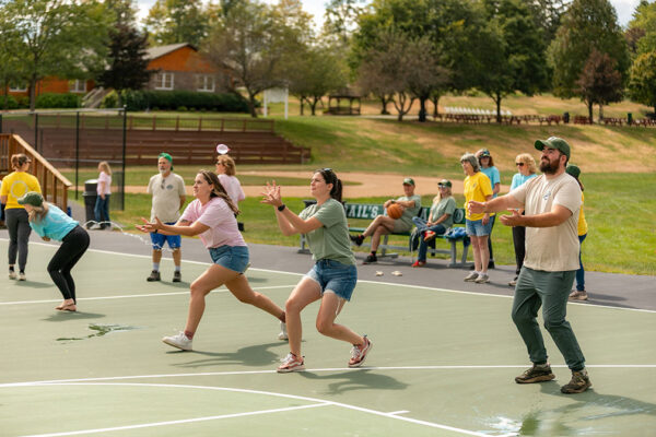Team-Building Activity at Corporate Retreat Employees participating in an outdoor team-building game during a corporate retreat.